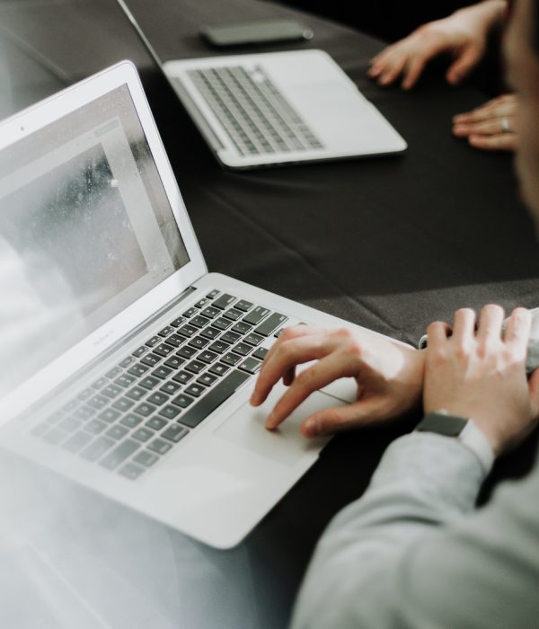 a man sitting in front of a laptop computer